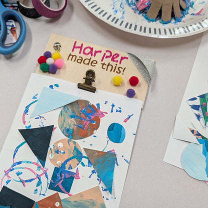 Children's art project with geometric shapes and a 'Harper made this!' sign on a table. Wendy Creative art class in Langford, BC